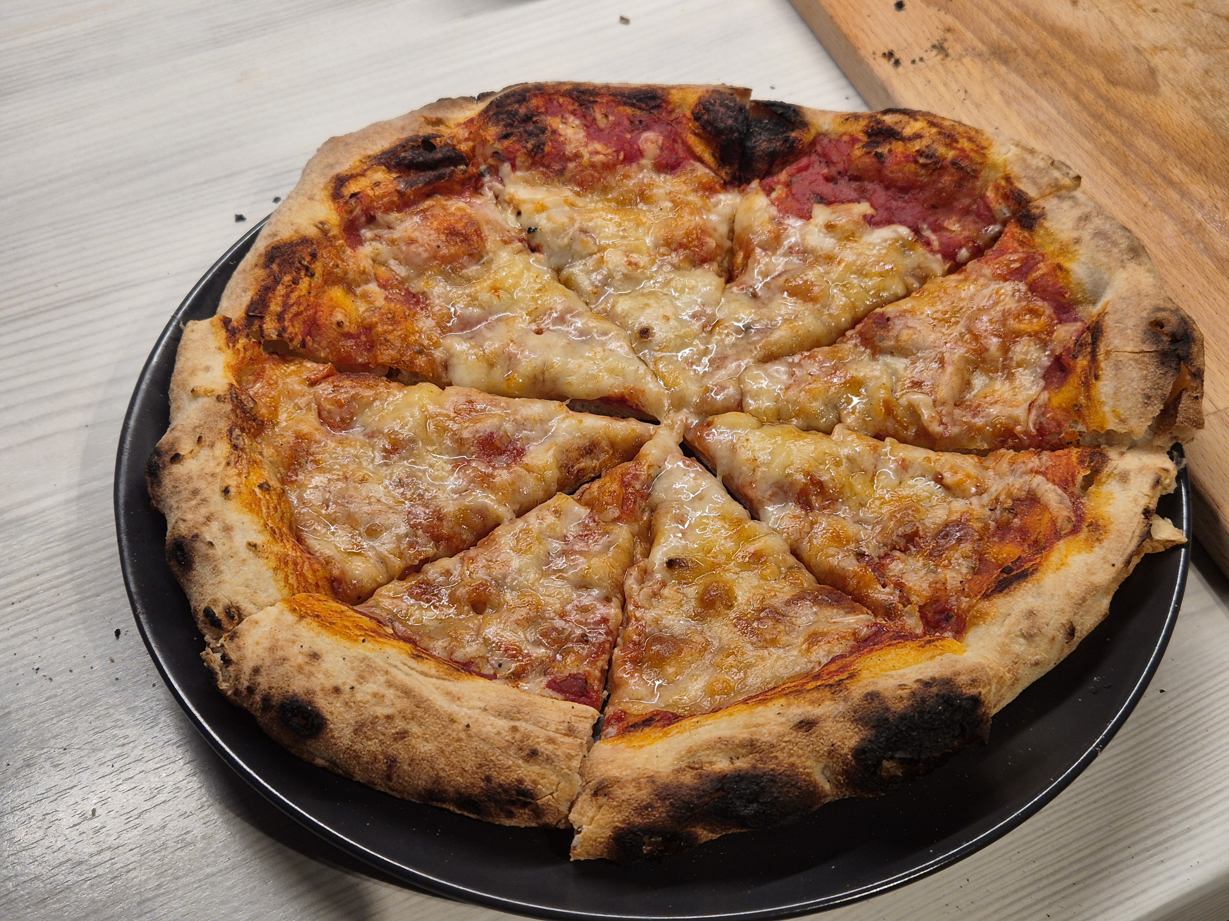 Reheated pizza. The crust is noticeably dry and crumbly.