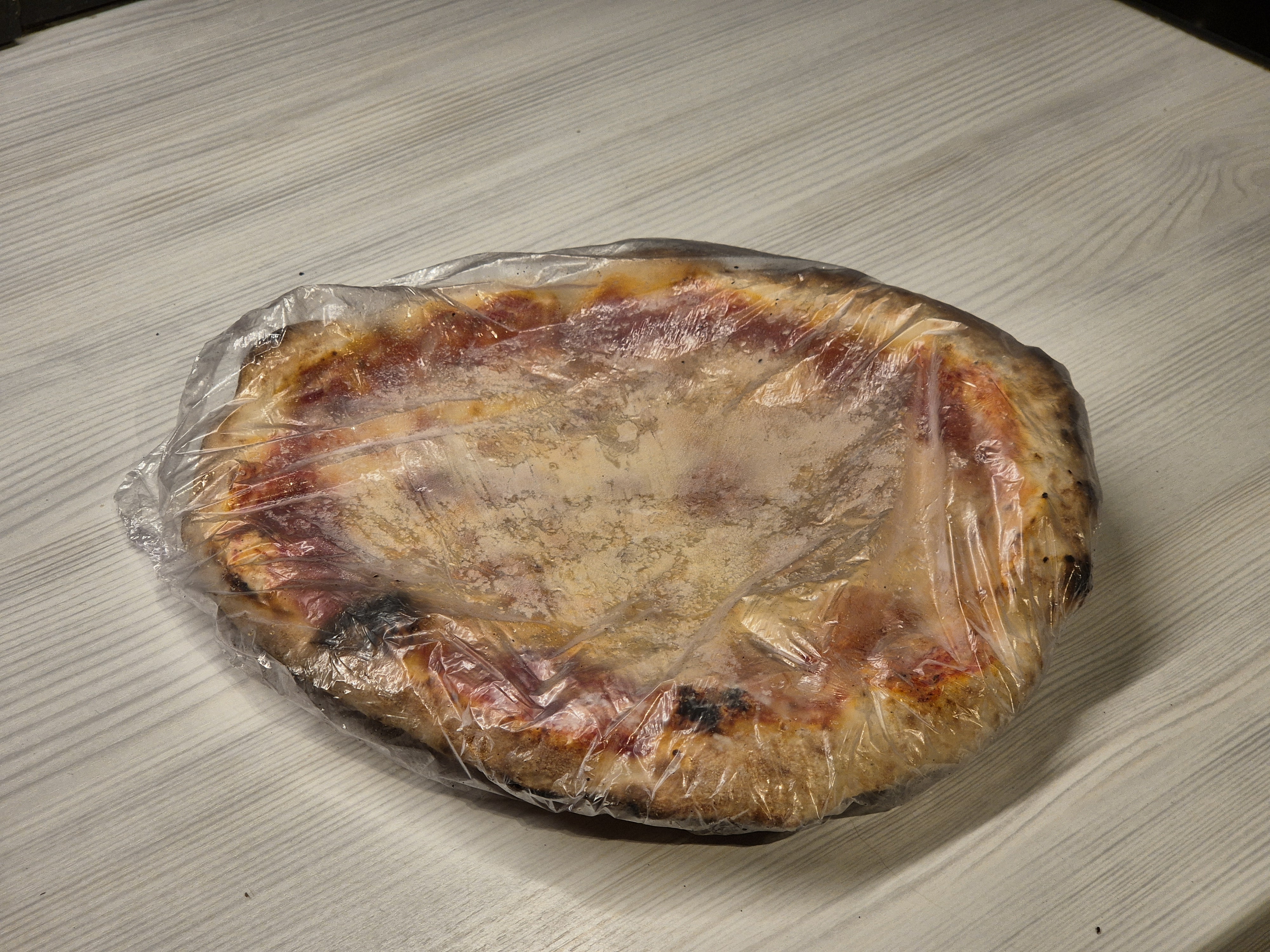 Frozen pizza straight out of the freezer.