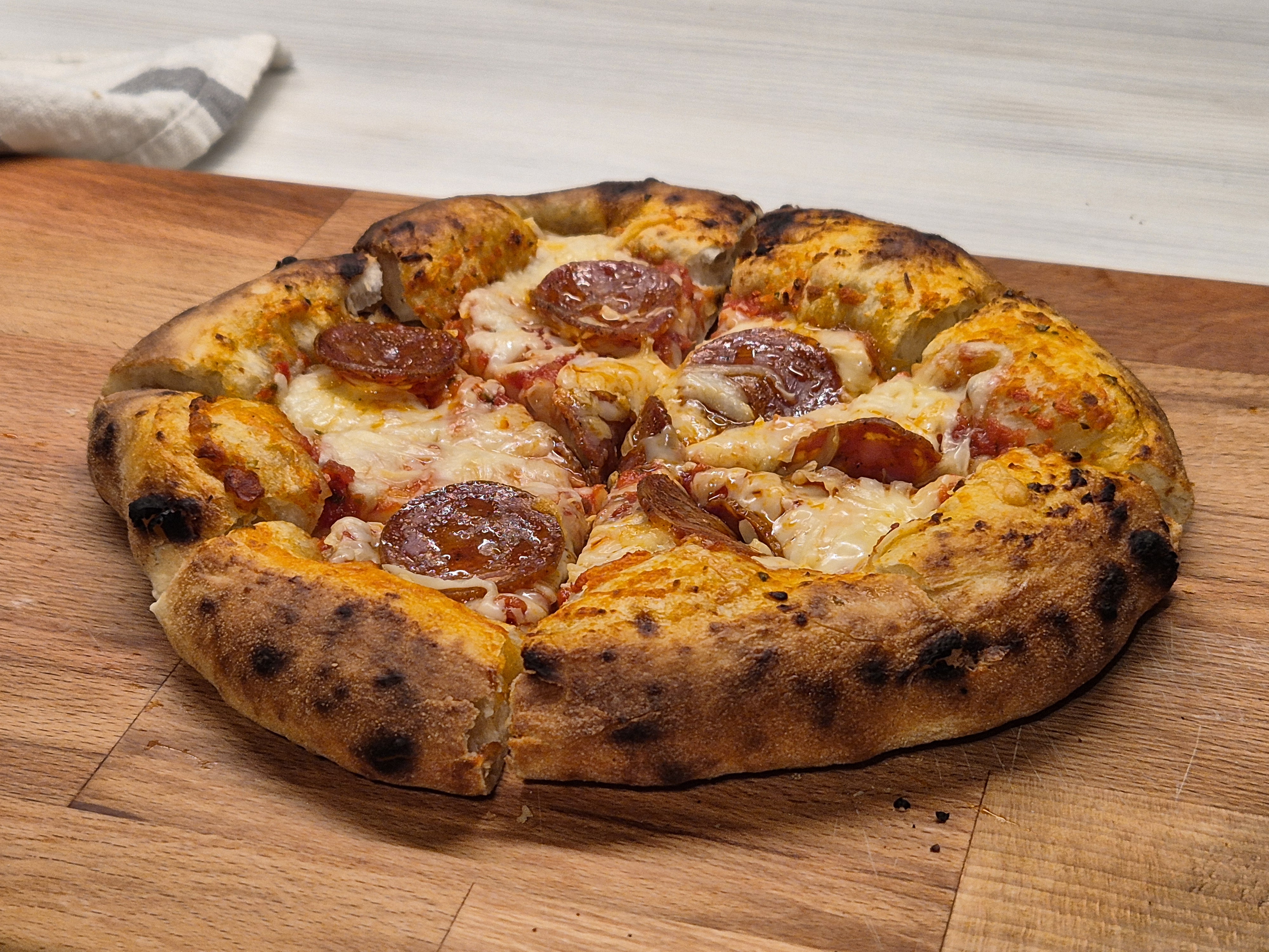 A second-batch pizza reheated.