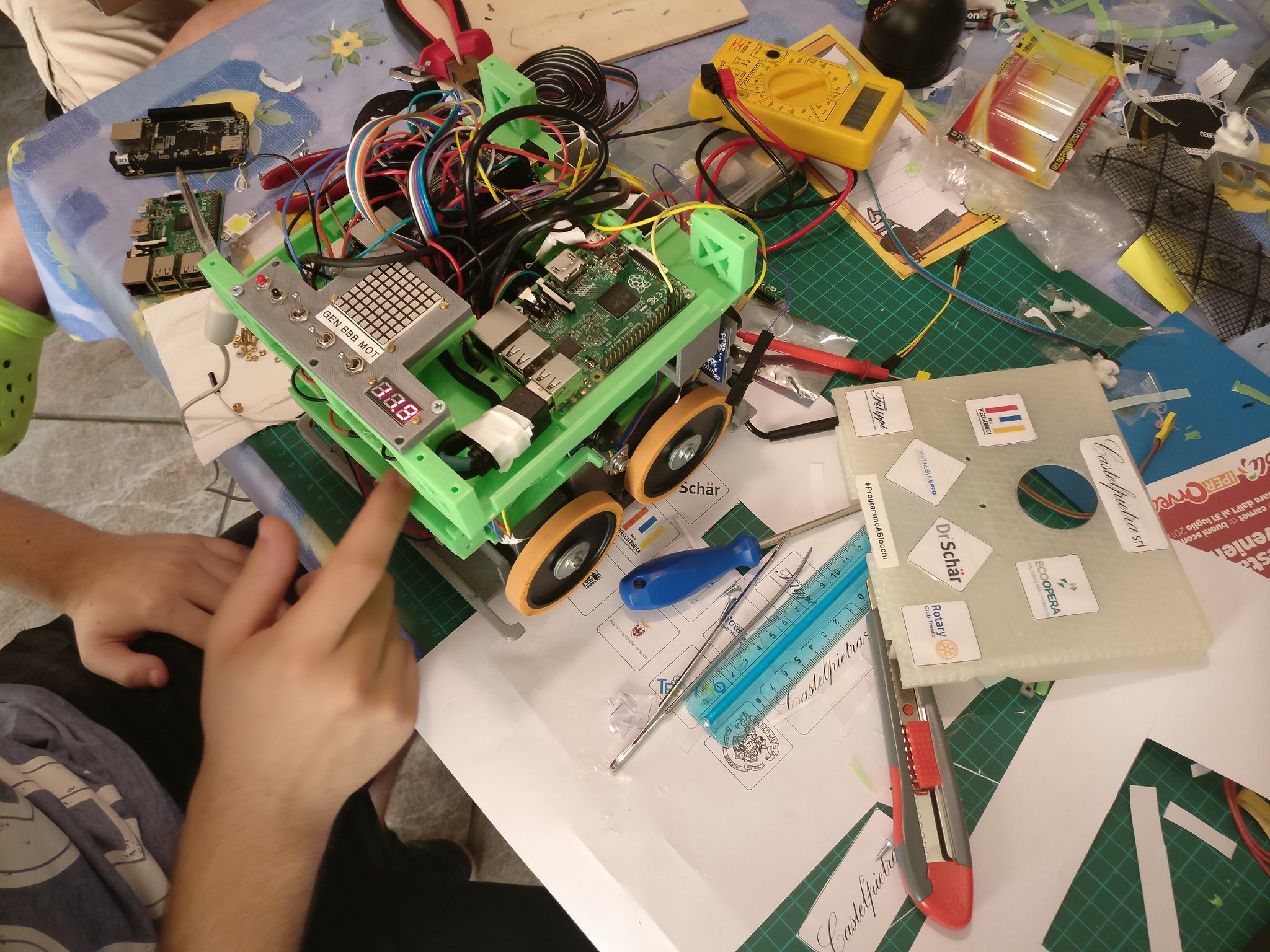 Daniele upgrading one of the modules. On the right, the front panel of the robot with the logos of our generous sponsors.